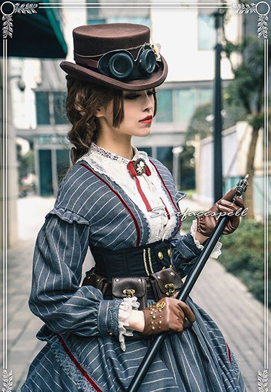 Picture of a woman wearing a hat with goggles holding a staff